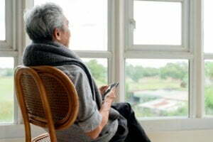 lonely senior elderly man male enjoying looking out window home view from his windowside view senior man who has chronic illness alzheimer s disease sitting living room