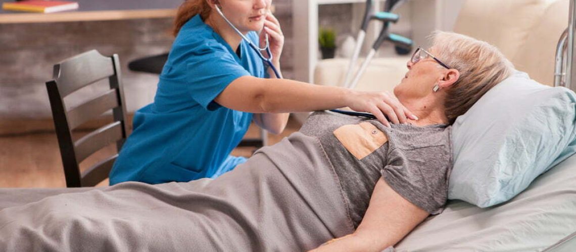 female-doctor-using-stethoscope-check-old-woman-heart-nursing-home