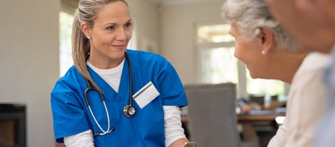 friendly-nurse-talking-with-old-couple