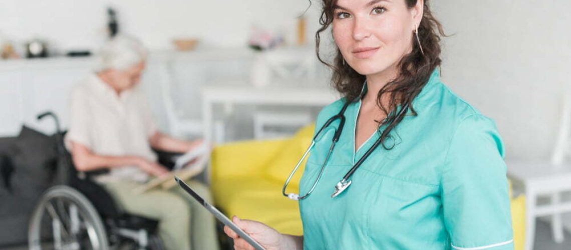portrait-female-nurse-holding-digital-tablet-standing-front-senior-patient-wheelchair