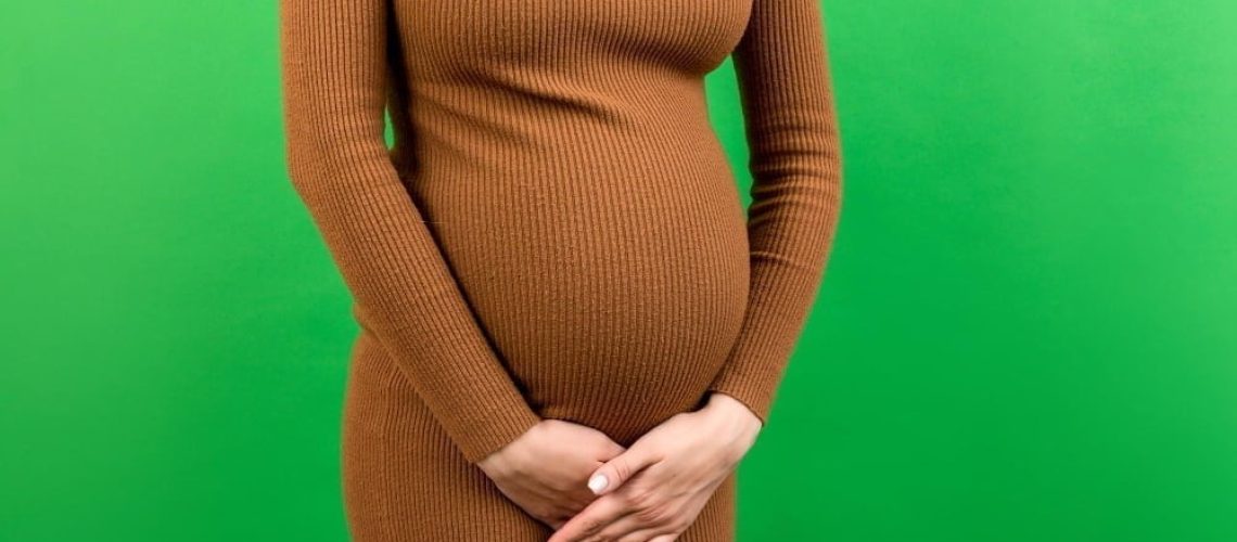 urinary-incontinence-during-pregnancy-abdominal-pain-during-pregnancy-maternity-healthcare-concept-colored-background